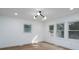 Bright bedroom with hardwood floors, modern light fixture, and large windows at 4500 Ridgeley Dr, Charlotte, NC 28208