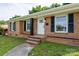Charming brick home with well-manicured lawn and welcoming front porch at 4500 Ridgeley Dr, Charlotte, NC 28208