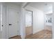 Clean hallway features wood-look flooring, white walls, and modern doors with black hardware at 4500 Ridgeley Dr, Charlotte, NC 28208