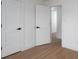 Clean hallway with white doors, black hardware, and wood-look flooring, creating a modern transition at 4500 Ridgeley Dr, Charlotte, NC 28208