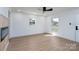 Well-lit living room featuring a modern fireplace and light wood flooring at 4500 Ridgeley Dr, Charlotte, NC 28208