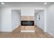 Bright living room featuring a fireplace and light wood flooring at 4500 Ridgeley Dr, Charlotte, NC 28208