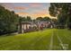 Brick home with manicured lawn and vibrant sunset sky backdrop at 4920 Parview S Dr, Charlotte, NC 28226