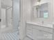 Bathroom with stylish floor tiling, single vanity, and tub-shower combo at 4920 Parview S Dr, Charlotte, NC 28226