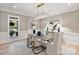 Bright dining room featuring modern lighting, elegant furnishings, and a serene view of the outdoors at 4920 Parview S Dr, Charlotte, NC 28226