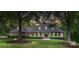 Charming brick home with manicured lawn, mature trees, and inviting front porch with classic columns at 4920 Parview S Dr, Charlotte, NC 28226