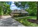 Beautiful brick home featuring an attached three-car garage, mature landscaping, and a welcoming front porch at 4920 Parview S Dr, Charlotte, NC 28226