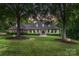 Charming brick home featuring a manicured lawn and mature trees, creating a serene and inviting atmosphere at 4920 Parview S Dr, Charlotte, NC 28226