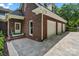 Classic brick home exterior with attached three-car garage, well-manicured landscaping, and paver driveway at 4920 Parview S Dr, Charlotte, NC 28226