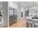 Modern kitchen with stainless steel appliances, white cabinetry, and a view of the staircase at 4920 Parview S Dr, Charlotte, NC 28226