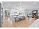 Open kitchen with large island, pendant lighting, stainless steel appliances, fireplace and adjacent seating area at 4920 Parview S Dr, Charlotte, NC 28226