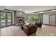 Cozy living room with a stone fireplace, wood floors, and french doors to the backyard at 4920 Parview S Dr, Charlotte, NC 28226