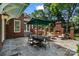 Outdoor dining area with brick fireplace and lush surroundings at 4920 Parview S Dr, Charlotte, NC 28226