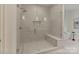 Modern glass enclosed shower with a built in bench and tile surround at 4920 Parview S Dr, Charlotte, NC 28226