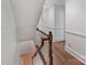 Hardwood staircase with white banisters and carpeted steps at 4920 Parview S Dr, Charlotte, NC 28226