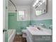 Bathroom features green tiling, wood-style floors, and modern fixtures at 504 Forest Ridge Dr, Shelby, NC 28152