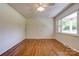 Bright bedroom with hardwood floors, ceiling fan, and large windows at 504 Forest Ridge Dr, Shelby, NC 28152