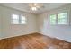 Cozy bedroom with hardwood floors, a ceiling fan, and natural light from the windows at 504 Forest Ridge Dr, Shelby, NC 28152