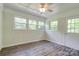 Bedroom boasts wood floors, a ceiling fan, and multiple windows at 504 Forest Ridge Dr, Shelby, NC 28152