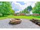 Brick fire pit in backyard with wood pile next to it, perfect for enjoying time outdoors with friends and Gathering at 504 Forest Ridge Dr, Shelby, NC 28152