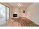 Open living room with a fireplace, sliding glass door, and wood-look flooring at 504 Forest Ridge Dr, Shelby, NC 28152