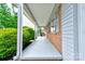 Covered front porch showing brick accents, white columns, and painted concrete at 504 Forest Ridge Dr, Shelby, NC 28152