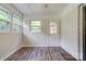 Bright sun room features wood floors, white wainscoting, and a door to the outside at 504 Forest Ridge Dr, Shelby, NC 28152
