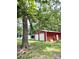 Spacious red outbuilding with two roll-up doors offering plenty of storage space at 511 Eastwood Dr, Albemarle, NC 28001