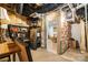 Unfinished basement area with exposed beams, storage shelves, and access to additional living space; ready for customization at 5214 Polo Gate Blvd, Charlotte, NC 28216