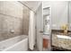 Tile bathtub featuring a shower, white curtain, and an open door to the rest of the bathroom at 5214 Polo Gate Blvd, Charlotte, NC 28216