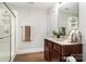Bathroom with a single vanity, granite countertop, wood floors, glass-enclosed shower, and neutral color scheme at 5214 Polo Gate Blvd, Charlotte, NC 28216