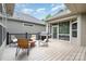 Relaxing outdoor deck with chairs, fire pit, grill, and screened-in porch, perfect for entertaining and enjoying the outdoors at 5214 Polo Gate Blvd, Charlotte, NC 28216