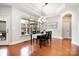Bright dining room with large window, elegant chandelier, and hardwood floors at 5214 Polo Gate Blvd, Charlotte, NC 28216