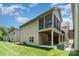 Back exterior of home with screened deck above a cozy covered patio at 5214 Polo Gate Blvd, Charlotte, NC 28216