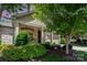 Inviting front exterior with stone accents, lush greenery, and a two-car garage, creating an appealing curb presence at 5214 Polo Gate Blvd, Charlotte, NC 28216
