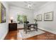 Bright home office featuring a large window, hardwood floors, and classic decor at 5214 Polo Gate Blvd, Charlotte, NC 28216