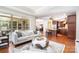 Open-concept living room and kitchen featuring hardwood floors, neutral colors, and plenty of natural light at 5214 Polo Gate Blvd, Charlotte, NC 28216