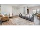Spacious living room with a sofa, armchairs, and a patterned rug, creating a cozy and welcoming atmosphere at 5214 Polo Gate Blvd, Charlotte, NC 28216