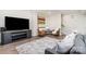 Cozy living room featuring a large TV, plush sofa, patterned rug, and seating area for relaxation and entertainment at 5214 Polo Gate Blvd, Charlotte, NC 28216