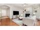 Bright living room with hardwood floors, fireplace, and neutral furniture at 5214 Polo Gate Blvd, Charlotte, NC 28216