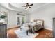 Bright main bedroom featuring balcony doors and a ceiling fan at 5214 Polo Gate Blvd, Charlotte, NC 28216