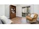Comfortable sitting area with a bookshelf, sliding glass doors to the outdoor patio, and cozy furniture at 5214 Polo Gate Blvd, Charlotte, NC 28216