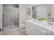Modern bathroom with glass enclosed shower, double vanity, and white cabinets at 543 Nesbe St # 2215, Lancaster, SC 29720