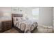 Cozy bedroom with decorative pillows, patterned bedding, and a well-lit window at 543 Nesbe St # 2215, Lancaster, SC 29720