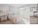 Bright bedroom with neutral tones, patterned bedding, and a bedside lamp on a nightstand at 543 Nesbe St # 2215, Lancaster, SC 29720