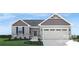 Charming single-story home featuring a two-car garage and well-maintained lawn at 543 Nesbe St # 2215, Lancaster, SC 29720
