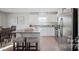 Well-lit kitchen with granite countertops, stainless steel appliances, an island and an adjacent dining area at 543 Nesbe St # 2215, Lancaster, SC 29720