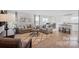 Open-concept living room featuring stylish furniture, large windows and wood-look flooring at 543 Nesbe St # 2215, Lancaster, SC 29720