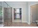 Bathroom featuring a glass-enclosed shower, walk-in closet, and decorative tile flooring at 552 Wyndham Ln, Marvin, NC 28173