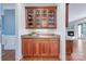 Elegant butler's pantry with glass-front cabinets, granite countertops, and hardwood floors at 552 Wyndham Ln, Marvin, NC 28173